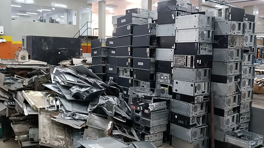 Stacks of discarded computer cabinets and metal scrap awaiting processing