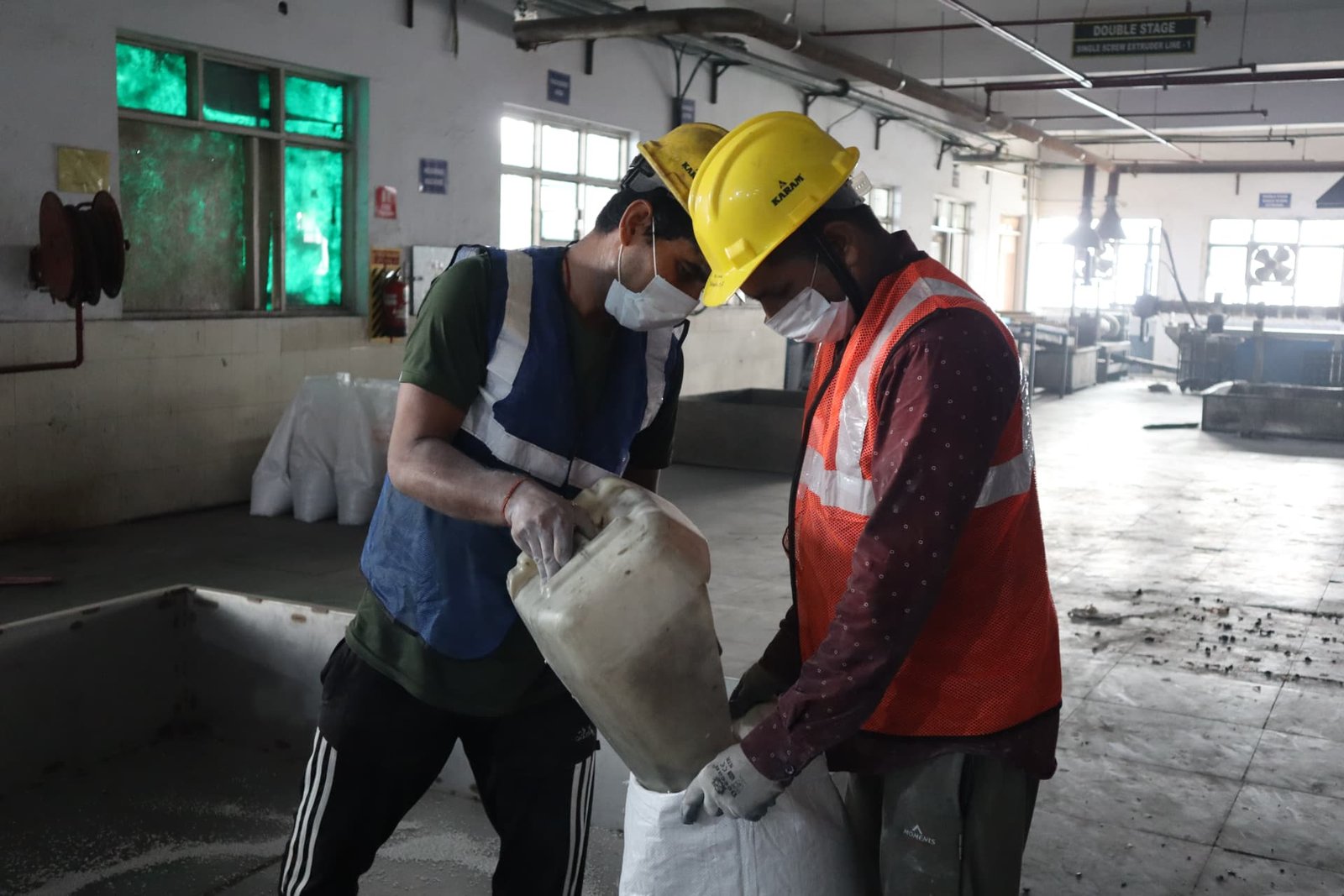 Deshwal team handling material with protective equipment
